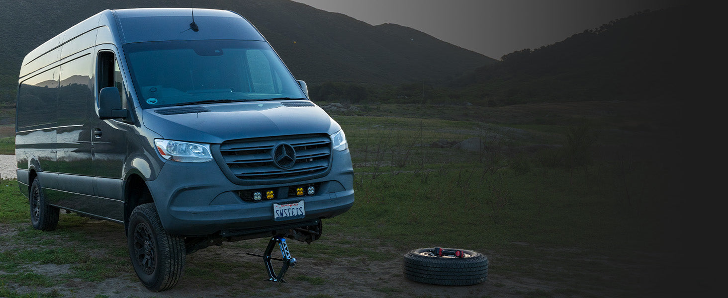 Sprinter van tire change with a AGM Scissor Jack HD on a dark background