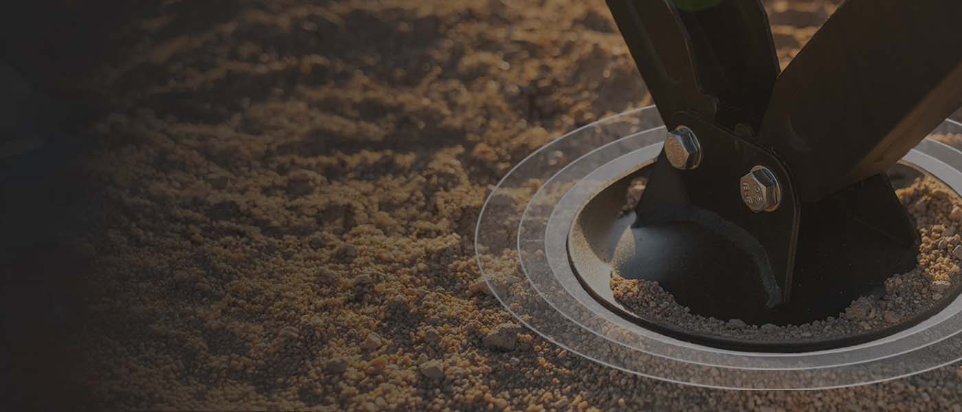 Close-up of AGM's patented GroundLoc pad, on an AGM Scissor Jack, compressing the sand.